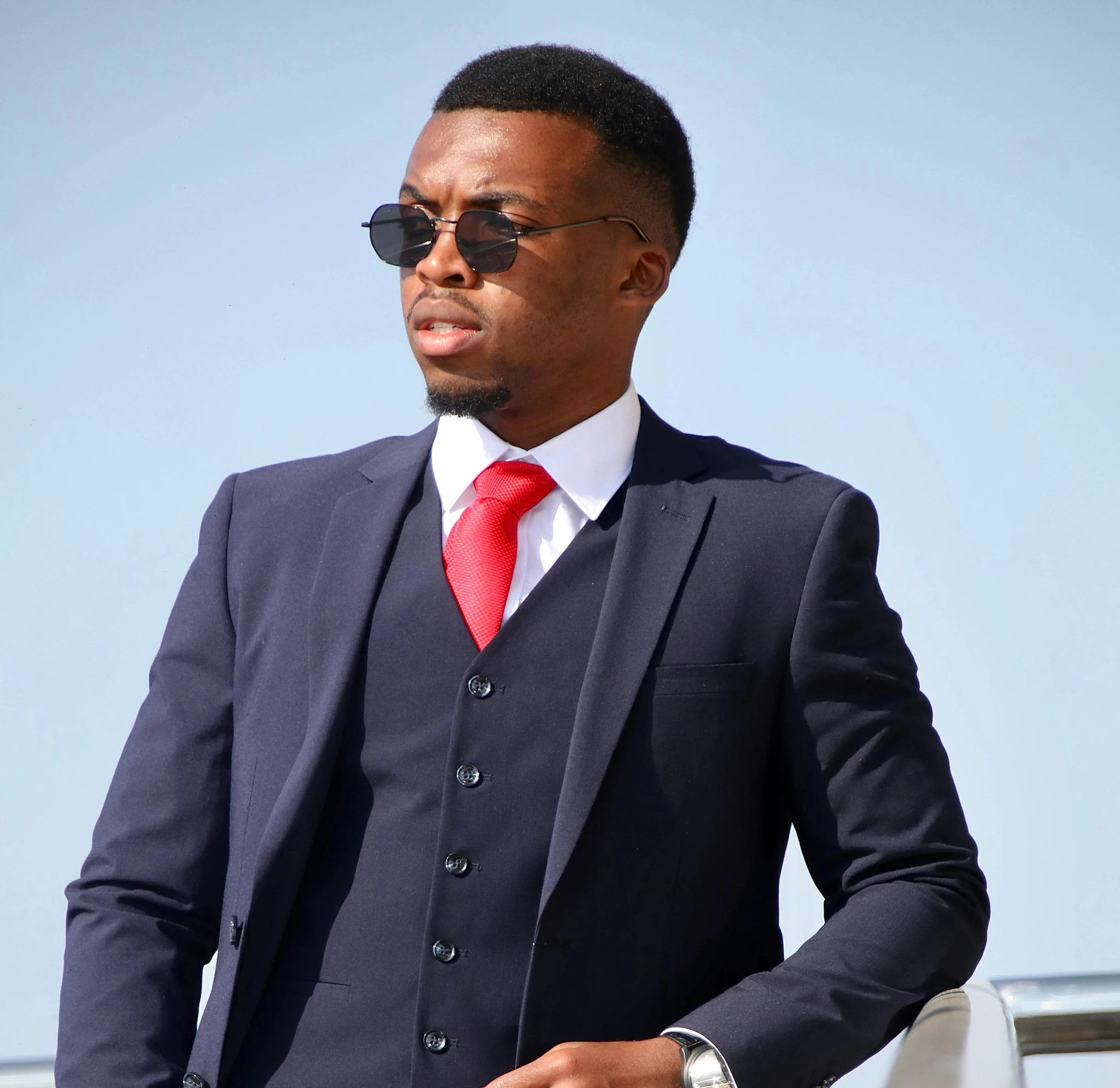 a man in a suit and red tie