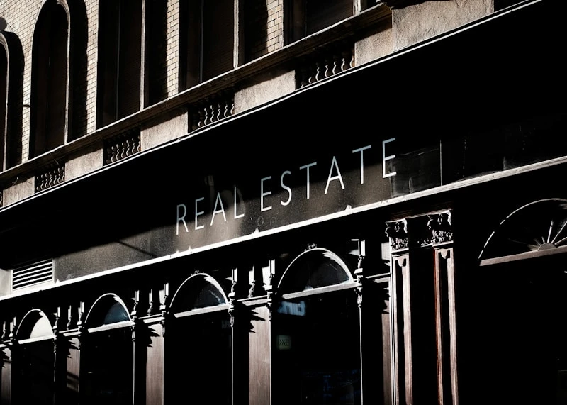 Real estate storefront sign on a building facade